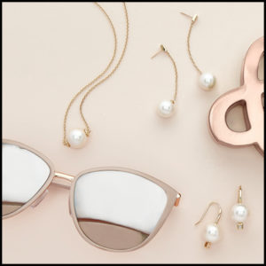 An Image of Pearl Jewelry and Sunglasses