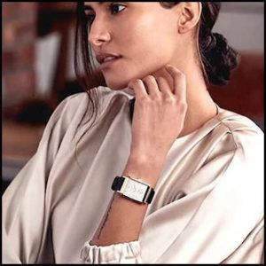 A Woman is Reflecting on her Wrist Watch