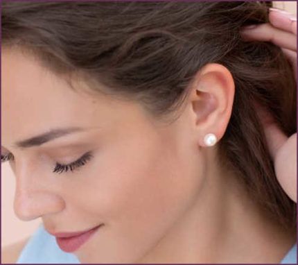 An Image of a Woman Showing Her Pearl Stud Earrings