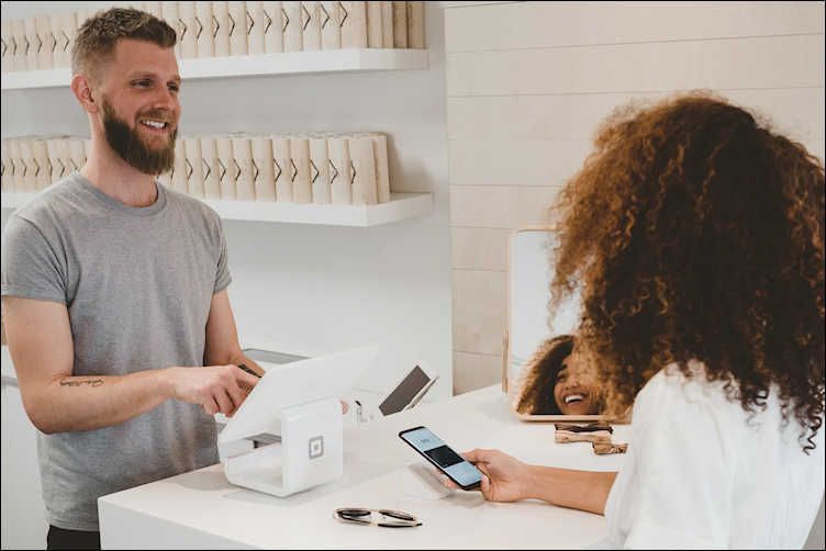 A Woman is in Discussion with the Salesperson 