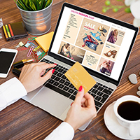 Woman Engaged in Online Shopping via Laptop