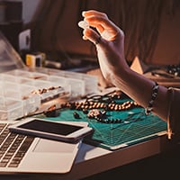 A Woman is Immersed in the Study of Jewelry Designs