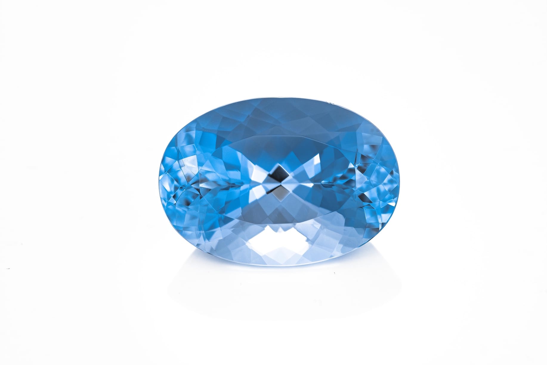 A blue oval shaped gem Description automatically generated