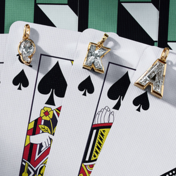 Three J’evar TYPE Initial Cut solitaires lab-grown diamond initial pendants—A, K, and Q—set in 18k yellow gold and displayed on Queen, King, and Ace of Spades playing cards.